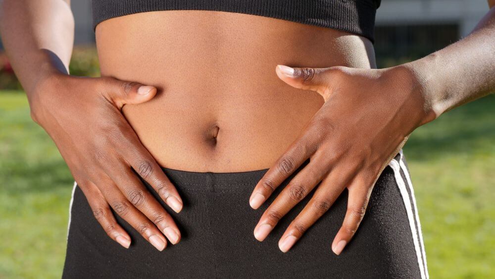 Woman feeing confident with her stomach.